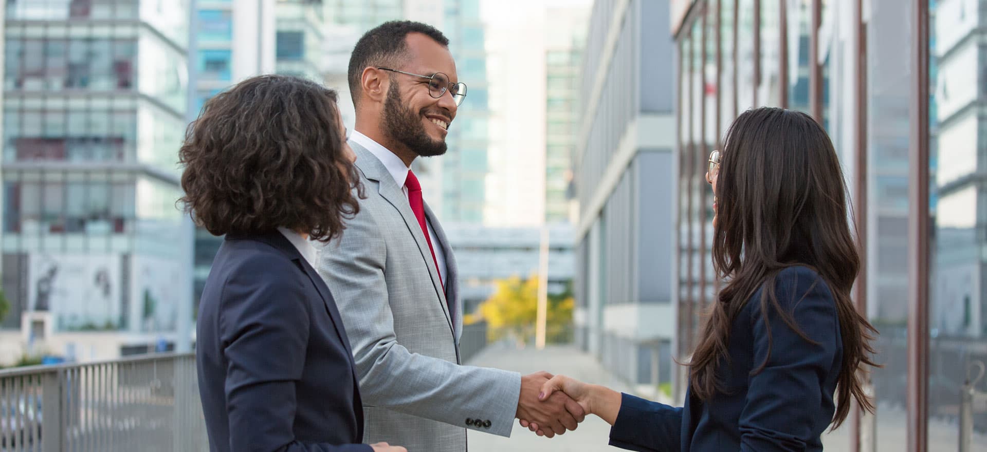 happy-positive-business-people-meeting-outside